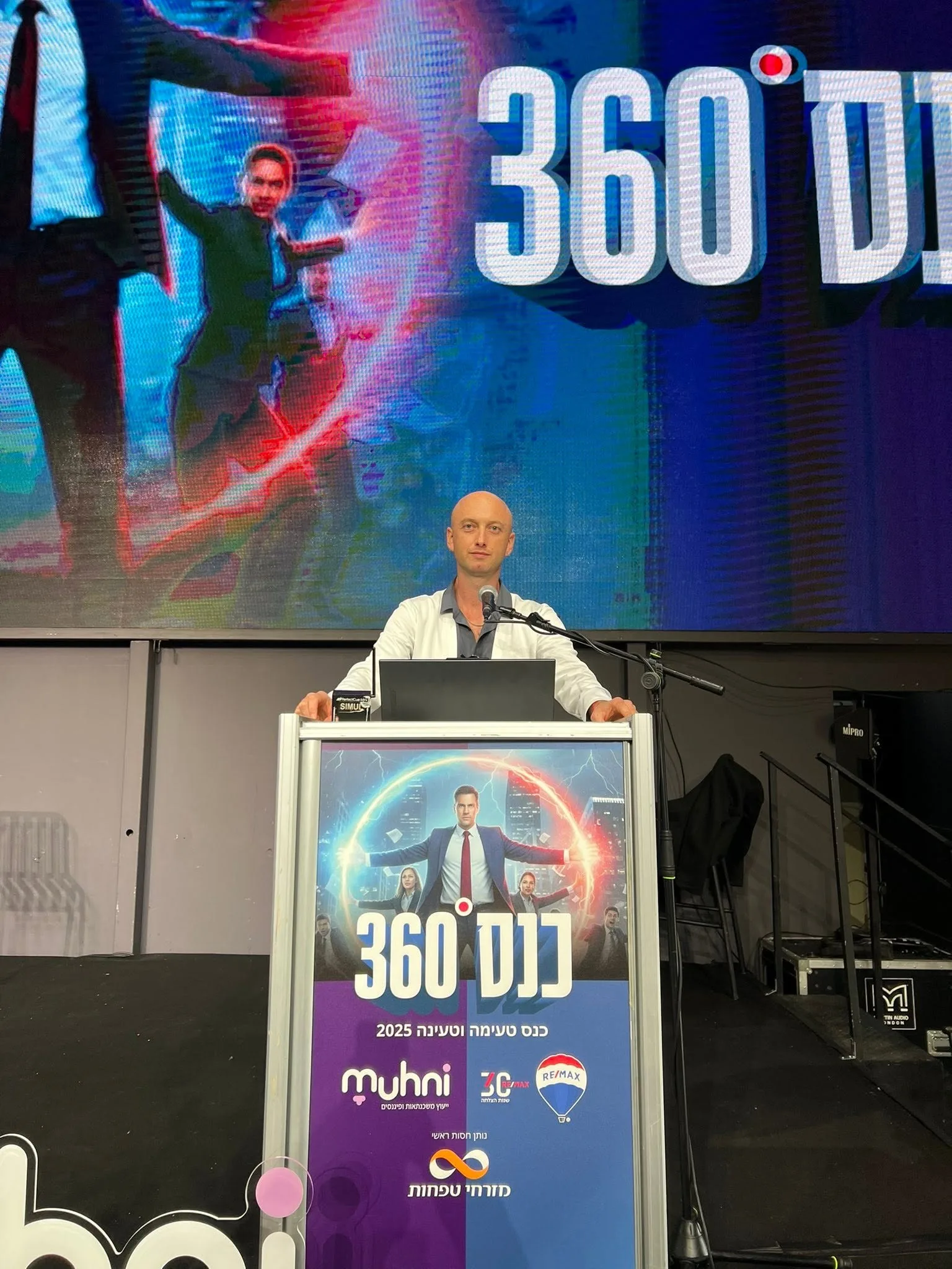 Alex Kap delivering an AI keynote on a large stage